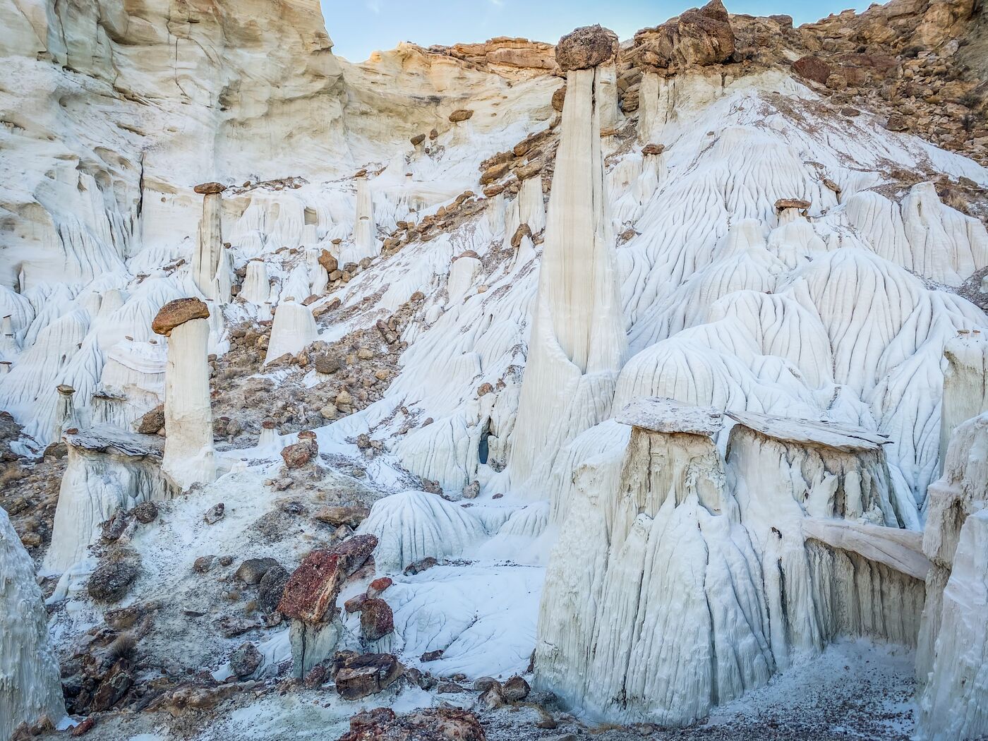 The main group of hoodoos rising out of the sculpted white base of the wash